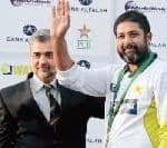 Inzamam-ul-haq waves to the crowd after receiving the life time achievement award from the Pakistan Cricket Board Chairman Dr. Nasim Ashraf (left) at the Gaddafi Stadium in Lahore. 